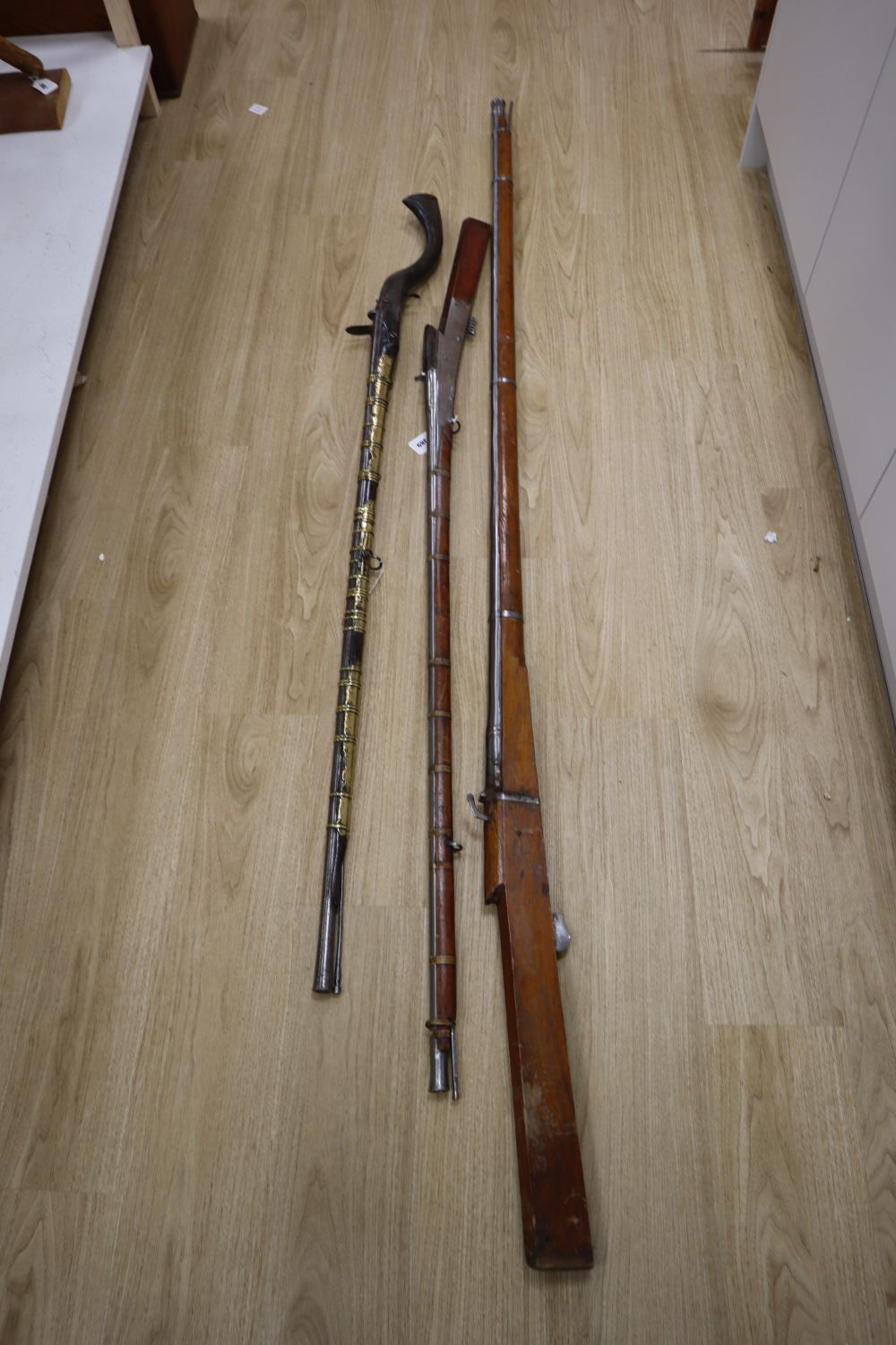 A long musket, overall 90 inches and two further longarms, all with ram-rods